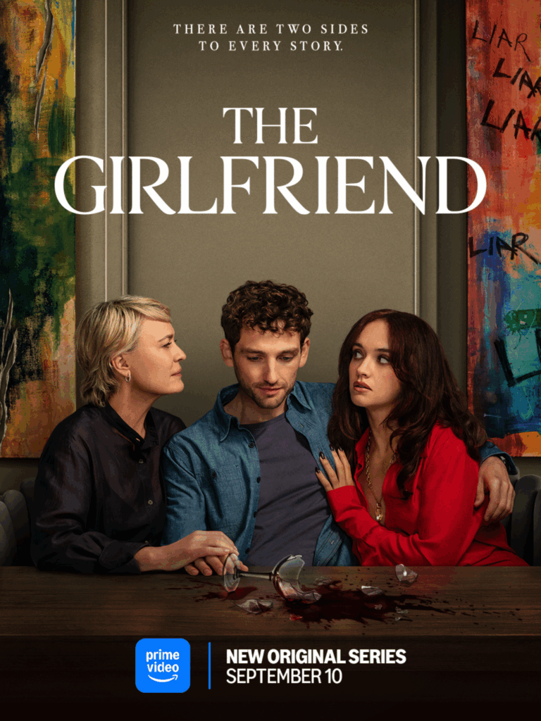 Three people sitting closely at a table with a broken wine glass and spilled red liquid in front of them.